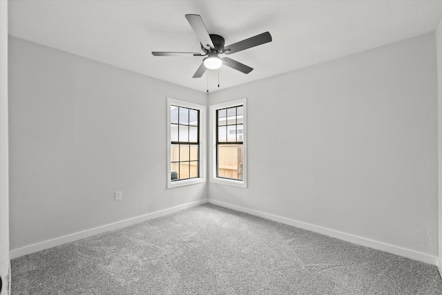 spare room featuring ceiling fan, baseboards, and carpet flooring