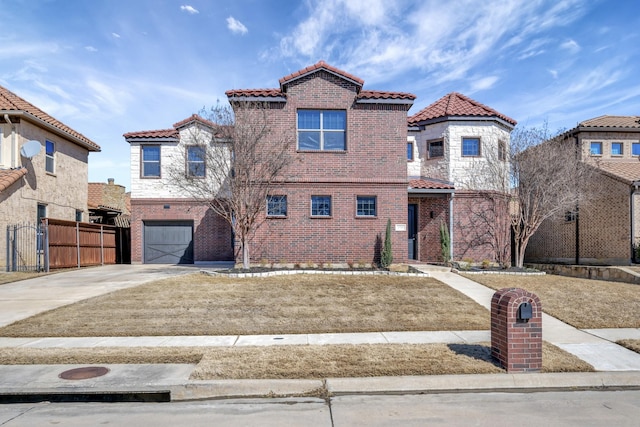 mediterranean / spanish house featuring driveway, a garage, a tile roof, fence, and brick siding