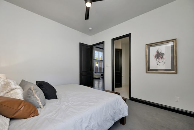 carpeted bedroom featuring baseboards and a ceiling fan