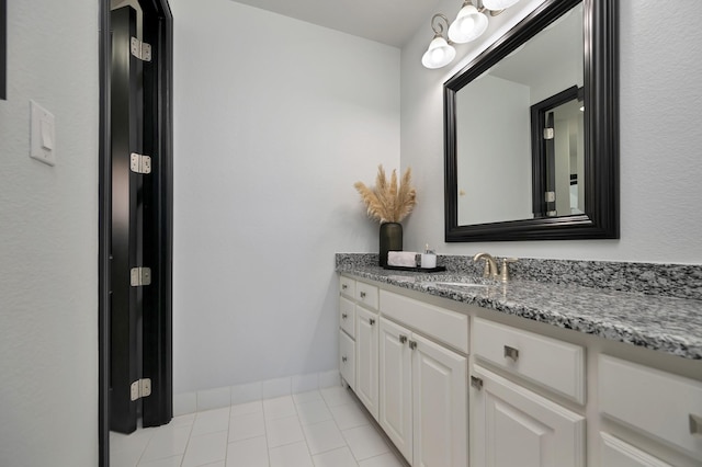 bathroom with tile patterned floors, vanity, and baseboards