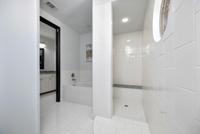 full bathroom with a walk in shower, tile patterned flooring, a garden tub, visible vents, and vanity