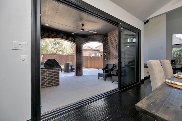 view of patio with ceiling fan and fence