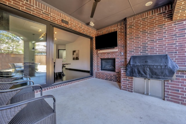 view of patio with ceiling fan and grilling area