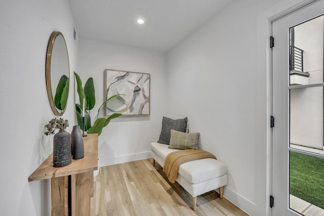 sitting room featuring visible vents, baseboards, wood finished floors, and recessed lighting