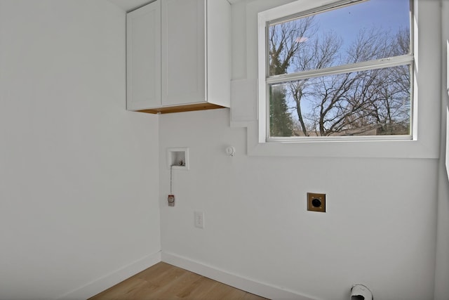 clothes washing area featuring washer hookup, baseboards, light wood-type flooring, cabinet space, and electric dryer hookup