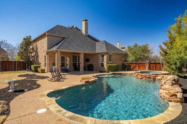 view of pool featuring an in ground hot tub, a patio, a fenced backyard, and a fenced in pool