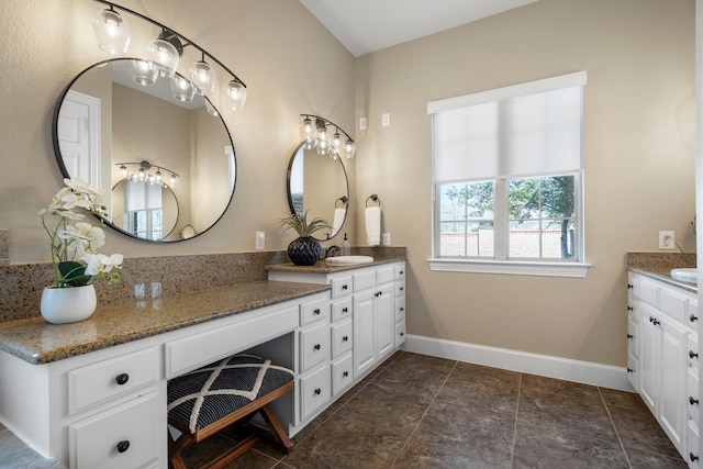 bathroom featuring baseboards and vanity