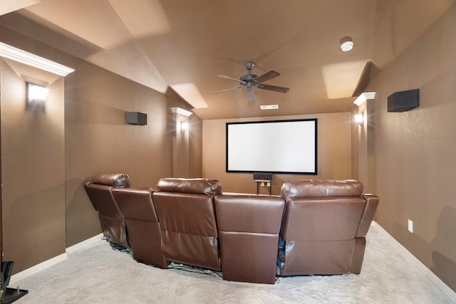 home theater featuring lofted ceiling, carpet, a ceiling fan, and baseboards