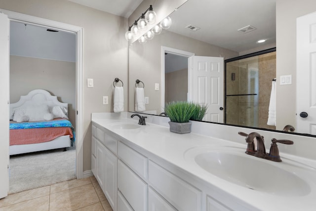 ensuite bathroom featuring ensuite bathroom, a sink, visible vents, and tile patterned floors