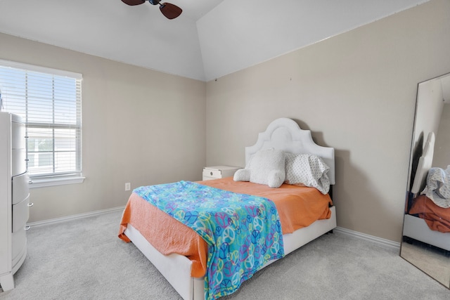 bedroom featuring light carpet, vaulted ceiling, a ceiling fan, and baseboards