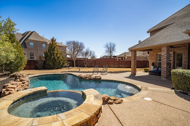 view of swimming pool featuring a patio, a fenced backyard, and a pool with connected hot tub