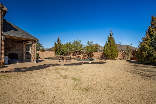 view of yard with a fenced backyard, a fenced in pool, and a patio