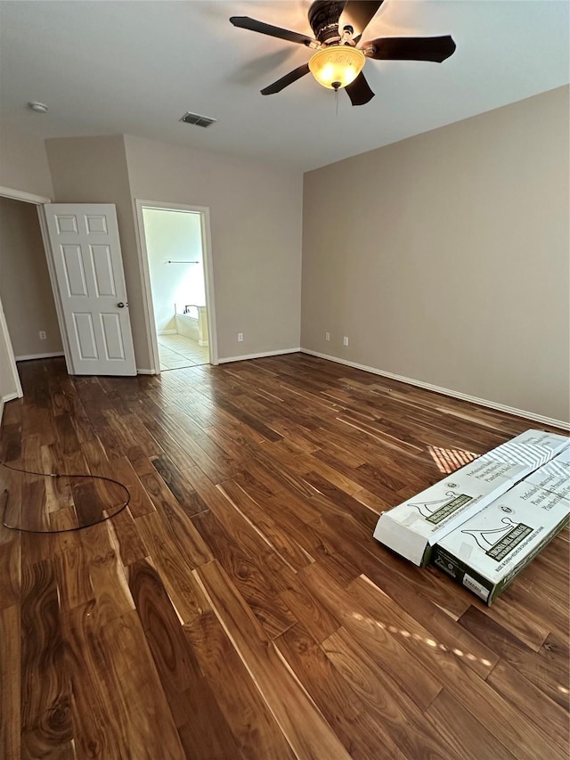 unfurnished room featuring visible vents, baseboards, a ceiling fan, and dark wood-style flooring