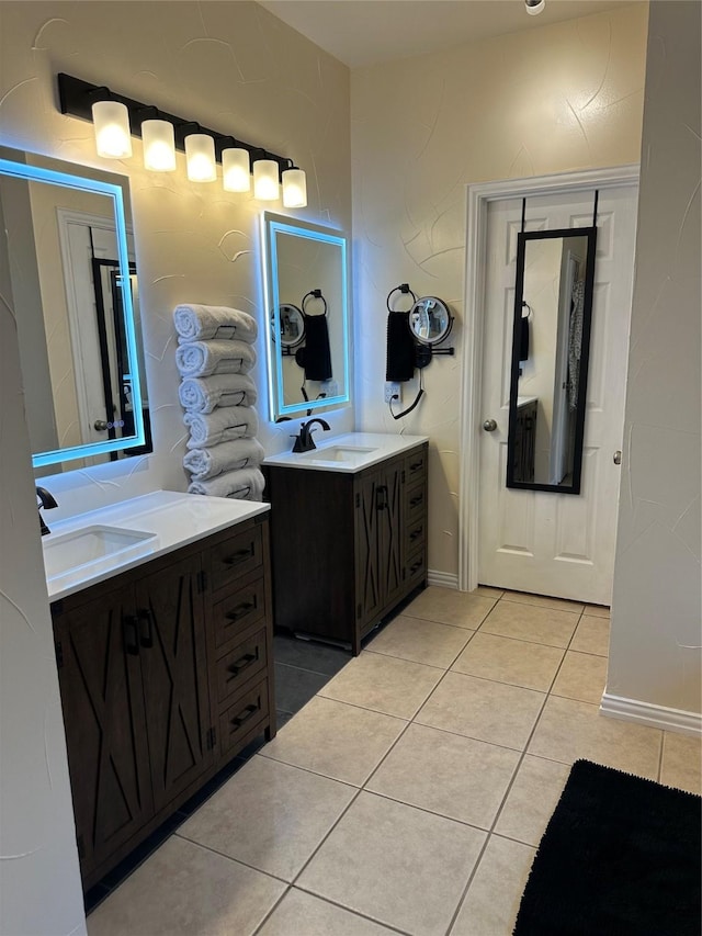 full bathroom with tile patterned flooring, two vanities, and a sink