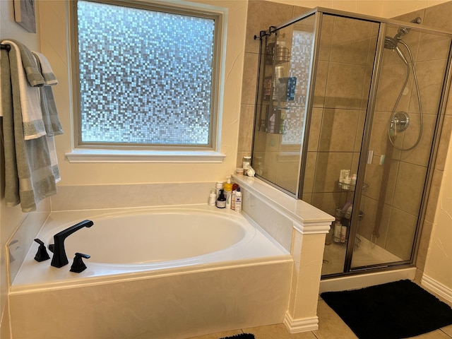 full bath featuring tile patterned floors, a garden tub, and a shower stall