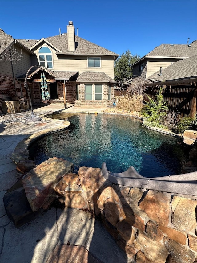 view of pool with a patio area, fence, and a fenced in pool