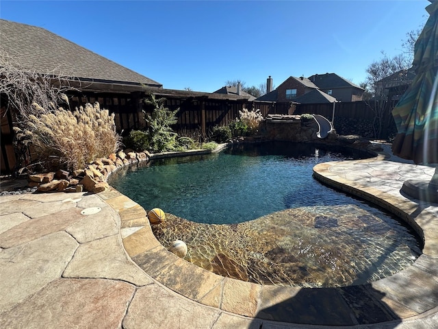 view of swimming pool featuring a patio, a fenced backyard, and a fenced in pool