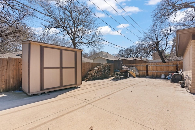 exterior space featuring a shed, a fenced backyard, and an outdoor structure