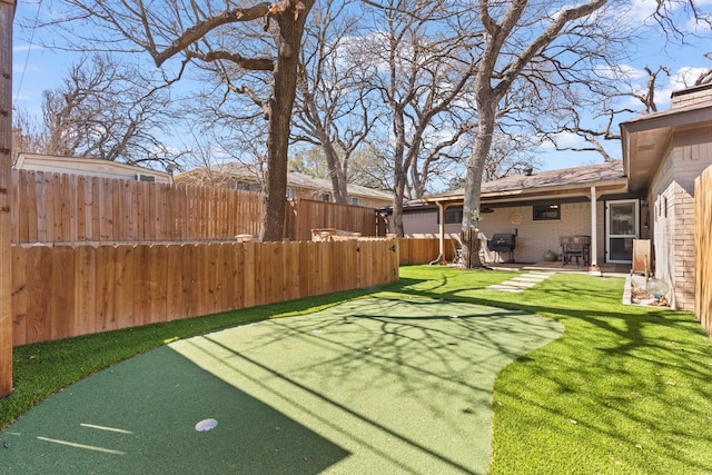 view of yard featuring fence and a patio