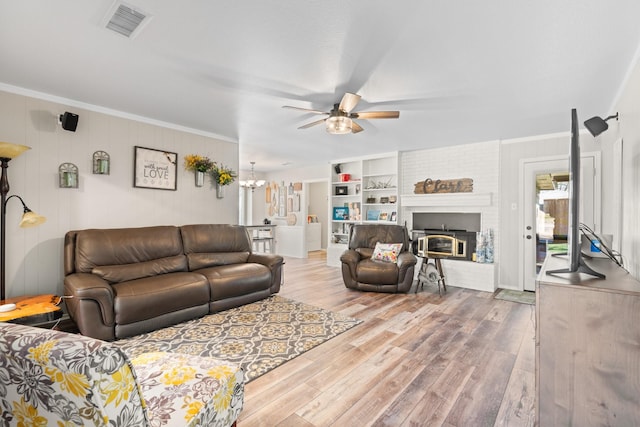 living room featuring ornamental molding, wood finished floors, and visible vents