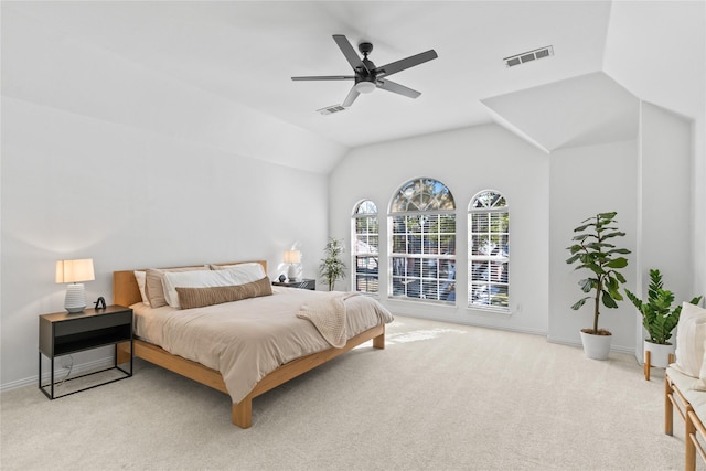 carpeted bedroom with ceiling fan, visible vents, vaulted ceiling, and baseboards