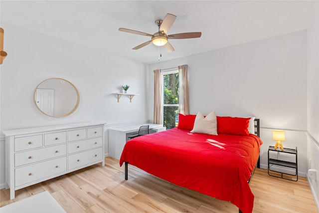 bedroom featuring ceiling fan, baseboards, and wood finished floors