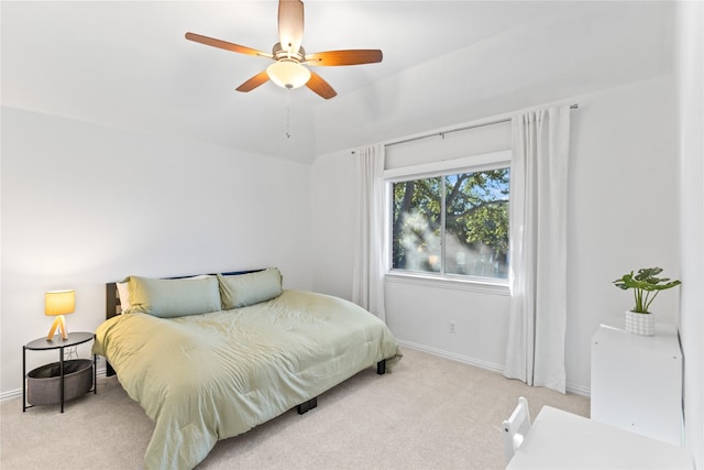 bedroom featuring vaulted ceiling, light colored carpet, ceiling fan, and baseboards