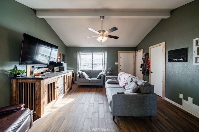 living room with vaulted ceiling with beams, ceiling fan, wood finished floors, visible vents, and baseboards