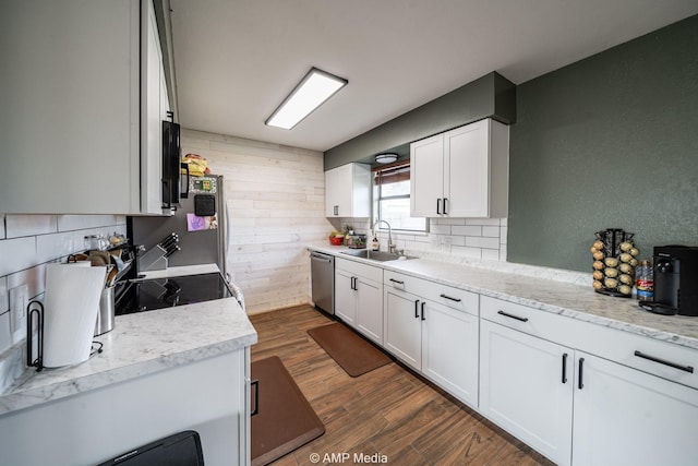 kitchen with decorative backsplash, dishwasher, dark wood-style flooring, white cabinetry, and a sink