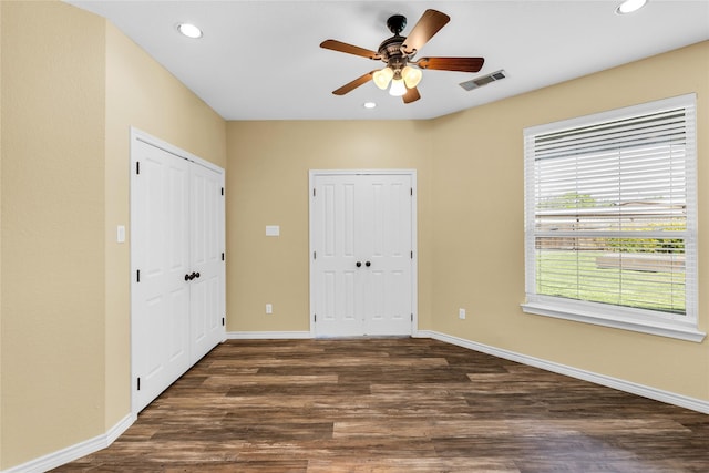 4031 Burleson Retta Rd, Burleson, TX 76028 - unfurnished bedroom featuring two closets, dark wood-style flooring, recessed lighting, baseboards, and a ceiling fan