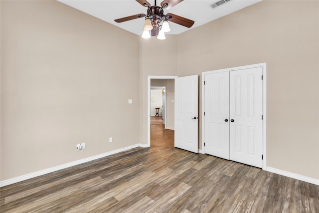 4031 Burleson Retta Rd, Burleson, TX 76028 - unfurnished bedroom featuring wood finished floors, baseboards, a closet, a towering ceiling, and ceiling fan