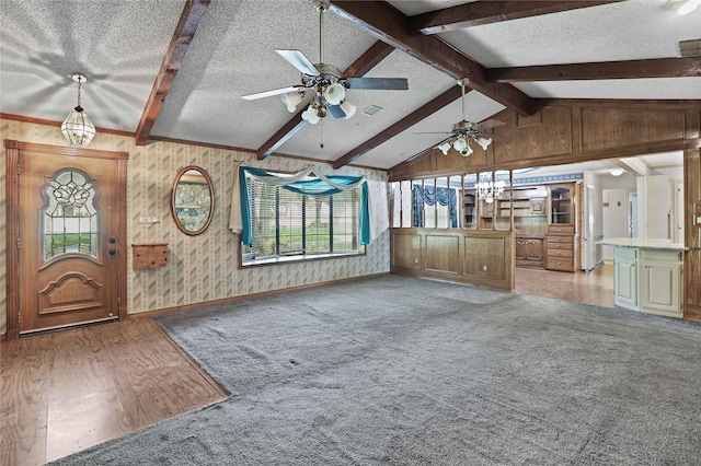 unfurnished living room with light wood-style flooring, light colored carpet, vaulted ceiling with beams, and a textured ceiling