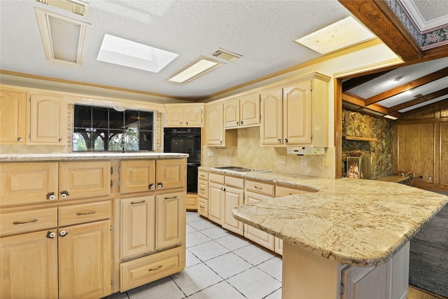 kitchen with dobule oven black, stainless steel gas stovetop, a peninsula, and light brown cabinets