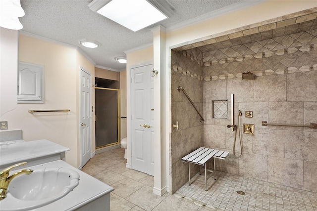 full bath featuring ornamental molding, a shower stall, a textured ceiling, vanity, and tile patterned floors