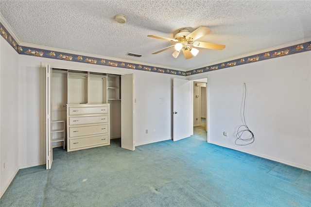 unfurnished bedroom with baseboards, visible vents, a textured ceiling, carpet floors, and a closet