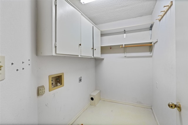 clothes washing area with cabinet space, baseboards, hookup for a washing machine, a textured ceiling, and electric dryer hookup