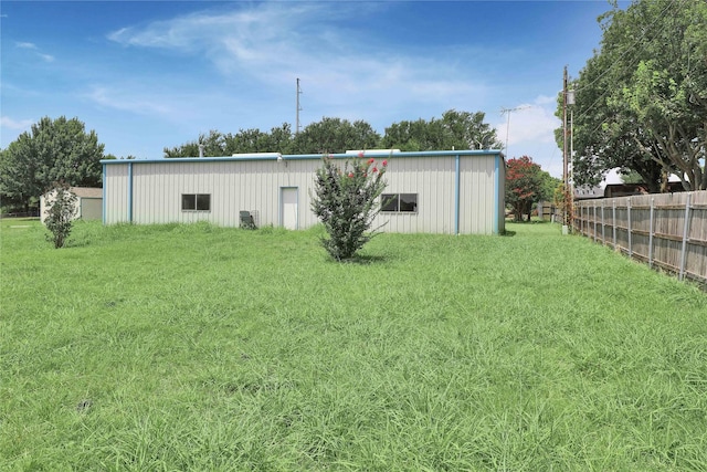 exterior space featuring fence and an outbuilding