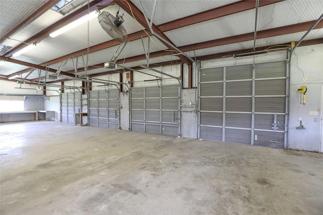 garage featuring metal wall and a garage door opener