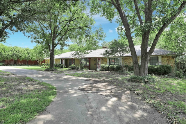 ranch-style home with brick siding and fence