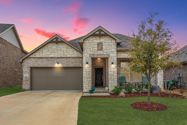 view of front of house featuring brick siding, driveway, an attached garage, and a lawn