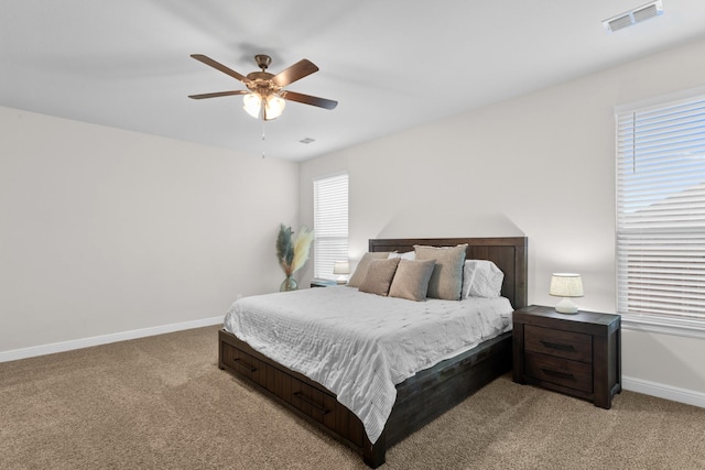 bedroom with light carpet, baseboards, visible vents, and ceiling fan