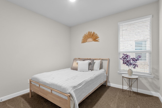 bedroom featuring carpet floors and baseboards