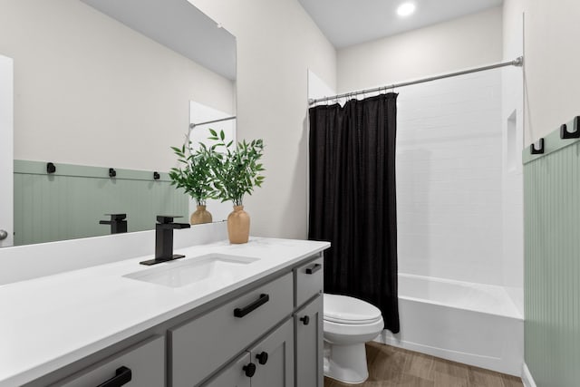 full bath with vanity, wood finished floors, toilet, and shower / bathtub combination with curtain