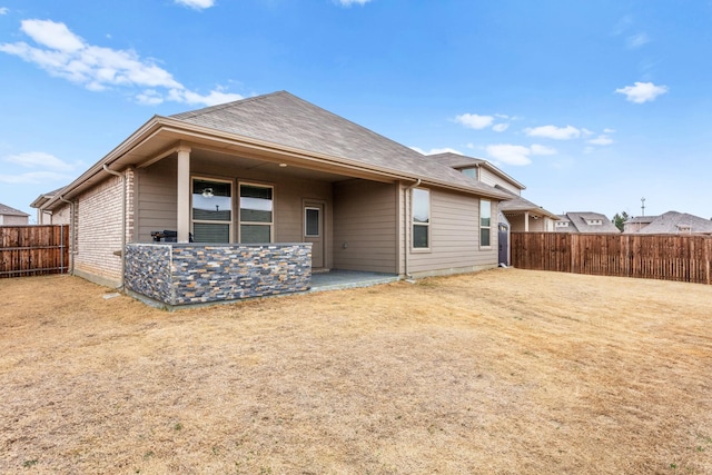 rear view of house featuring a patio area and a fenced backyard