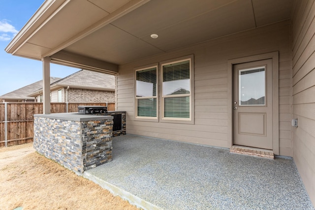 view of patio featuring fence