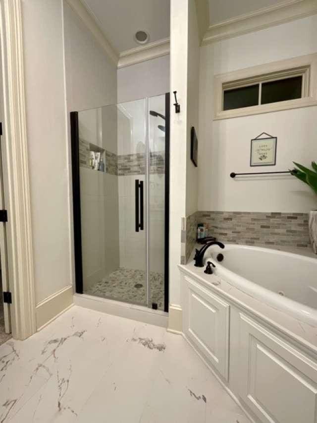 1933 Woodberry Ave, Shreveport, LA 71106 - bathroom with ornamental molding, a shower stall, marble finish floor, and a garden tub