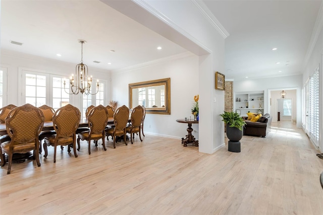 dining area with baseboards, light wood-style flooring, an inviting chandelier, crown molding, and recessed lighting