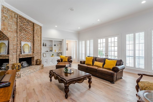 living room with a fireplace, crown molding, and light wood-style flooring