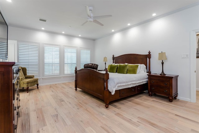 bedroom with ornamental molding, light wood-type flooring, and visible vents