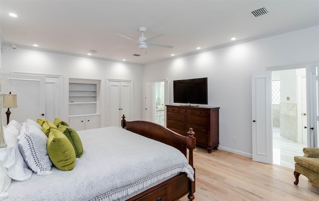 bedroom featuring light wood-style floors, recessed lighting, visible vents, and multiple closets